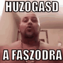 a shirtless man with a beard is making a funny face with a foreign language .