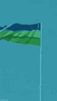 a colorful flag is waving in the wind on a pole .