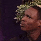 a close up of a man 's face with a purple background .