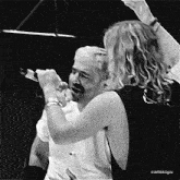 a black and white photo of a man singing into a microphone with the hashtag airbaggifs