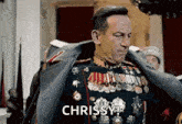 a man in a military uniform is holding his jacket over his shoulder and says chrissy .