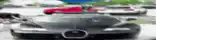 a blurred image of a bugatti veyron driving down a street .