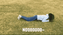 a woman laying on her stomach in a field with the words no000000 written on the bottom