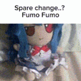 a stuffed doll with blue hair and red eyes is sitting on a bed with the caption spare change fumo fumo