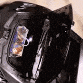 a black car with the trunk open and a bag in the back