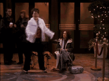a woman in a white fur coat is dancing in a room