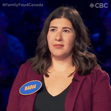 a woman wearing a name tag that says nadia on it