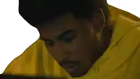 a man in a yellow hoodie with the letter h on the front
