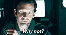a man is sitting in a car and says why not .