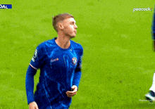 a soccer player in a blue shirt with peacock written on the bottom of his shorts