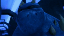 a blue monster with spikes on it 's head is standing in a dark room
