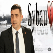 a man in a suit and tie is standing in front of a sign that says sybau