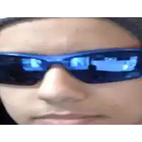 a close up of a person wearing sunglasses with a reflection