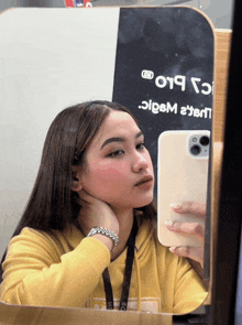 a woman taking a selfie in front of a mirror that says 019 on the top