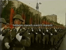 a group of soldiers marching in a parade with the words soldaten marsch marsch marsch