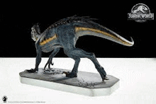 a statue of a dinosaur is standing on top of a white table .