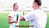 a woman in a vw shirt is holding a microphone and talking to a man