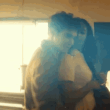 a man and a woman are dancing together in a room .