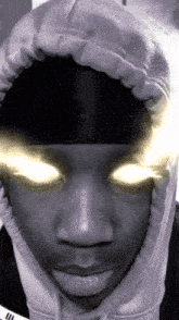 a close up of a person 's face with glowing eyes and a hoodie that says adidas on it