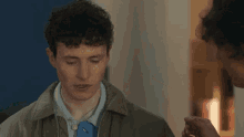a man putting a collar on another man 's ear