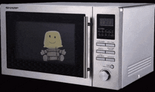a silver sharp microwave oven with a smiley face on it