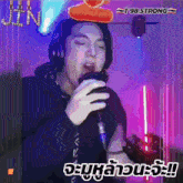 a man wearing headphones is singing into a microphone