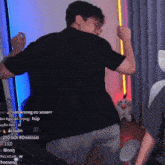 a man in a black shirt is dancing in front of a screen that has 250 goi roi written on it