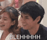 a man and a woman are smiling and the man is saying blehhhh .