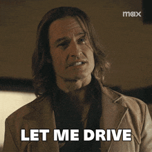 a man with long hair says let me drive in front of a max logo