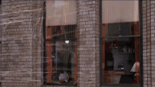 a brick building with a window that is covered in duct tape