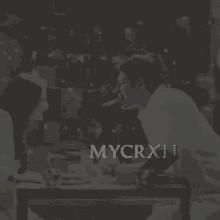 a man kissing a woman with the word mycrxn below