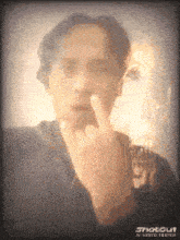 a man is giving the middle finger in a photo taken by shotgun