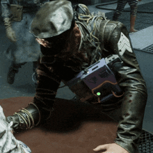 a man in a leather jacket has a purple device on his chest