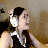 a woman wearing glasses and headphones is sitting in a chair with a corsair logo on it