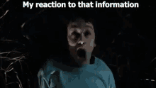 a man in a blue shirt is screaming in the dark in a forest .