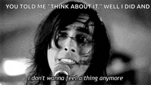 a woman is singing into a microphone in a black and white photo with a quote .