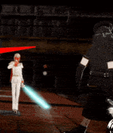 a man in a white suit stands next to a man in a black suit holding a sword