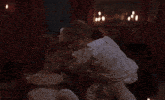 a man in a white shirt holds a woman 's hair