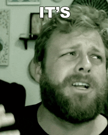 a man with a beard has a caption that says it 's on his face