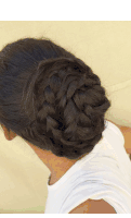 a woman with braided hair in a bun wearing a white shirt