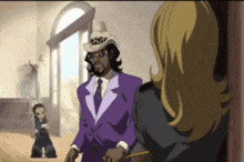 a man in a purple suit is talking to a woman in a room