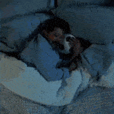 a man in blue pajamas is laying on a bed with a white pillow