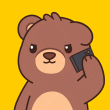 a brown teddy bear talking on a cell phone