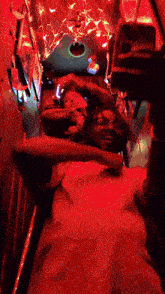 a man is taking a selfie in a dark room with red lights