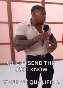 a man holding a microphone with the words " when i send this just know you not qualified "
