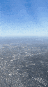 an aerial view of a large city with a blue sky