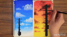 a person is painting a picture of a telephone pole with the words made in animotica on the bottom