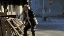 a man in a suit and tie is walking down a street with a stop sign in the background