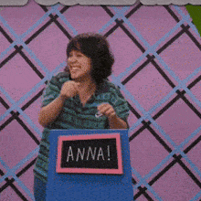 a woman stands behind a podium that says anna on it