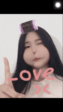 a woman with a curler on her head says love